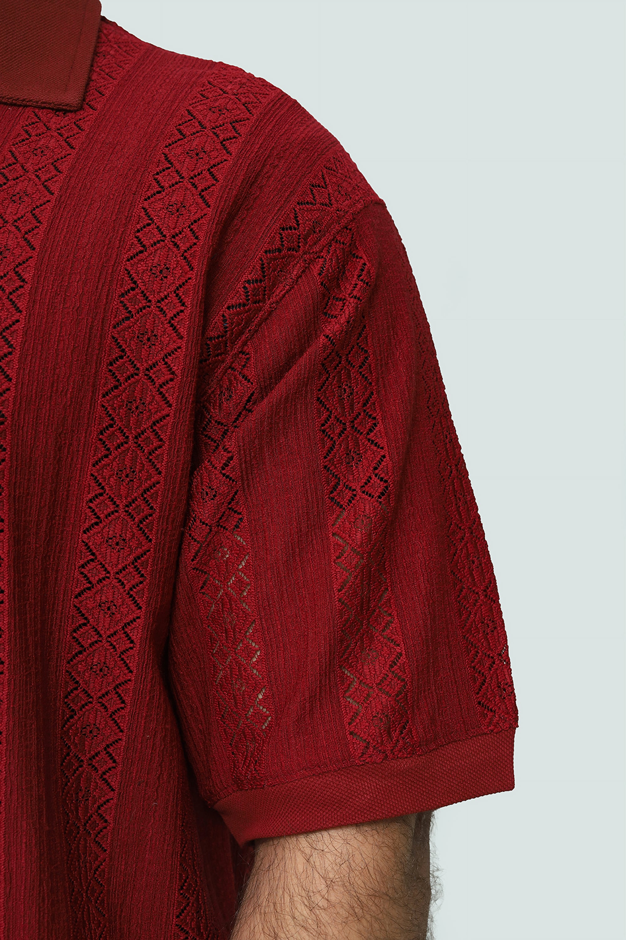 Red textured shirt on a light gray background